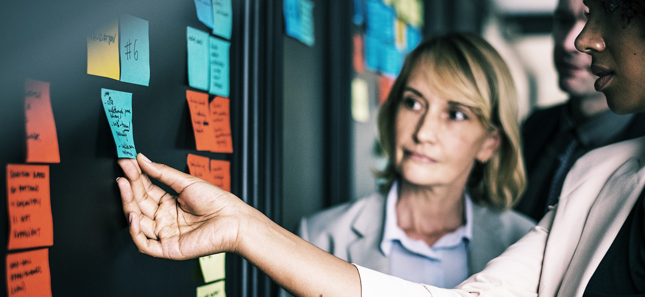 image of people interacting with post-it notes on wall